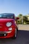 Small Red Italian Car parked in the Street