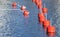 Small red mooring buoys in a row