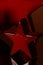 small red star on a dark red background and a reflecting surface for xmas backgrounds