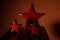 small red stars on a dark red background and a reflecting surface for xmas backgrounds