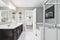 A small renovated bathroom looking towards a bedroom.