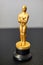 A small replica of the Oscar figure. A symbol of achievements in cinema. Selective focus