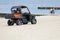 A small rescue vehicle on the beach