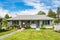 Small residential duplex house with concrete pathway over front yard