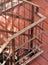 Small resort hotel staircase with brown vintage retro italian style simple wrought iron fence