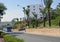 A small resort town on the Mediterranean coast. Bright sunny day, blue sky, road, palm trees, hotel