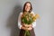 Small retail flower shop. Botanical gardening expertise. Celebrating with flowers. Owner of a floral store. Cheerful female