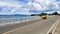 Small rickshaw riding through a road surrounded by the sea in Surigao Del Norte, the Philippines