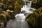 Small river flowing over rocks at Glenarriff Woods Reserve, Ireland, part of the Ring of Kerry, long exposure to smooth out the