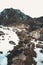 Small river in the massive mountains during winter with all covered in snow