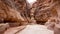 Small road between steep cliffs of sandstone rock