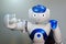 A small robot with a human face and a humanoid body. Artificial intelligence - AI. Blue-and-white robot.