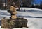 A small rock arrangment in a snow covered field on a bright mid winter day