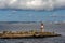 Small rocky island Harmaja with little lighthouse and metal tower in Gulf of Finland