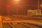 A small roofless train station at night in the Czech Republic. Added haze effect