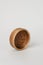 A small round wooden bowl on a white background. A nice little bowl made of wood