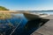 Small row boat moored at the pier by springtime morning