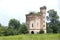 Small ruined abandoned castle overgrown in vegetation