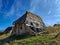 Small ruined wooden house built in traditional style found in distant  mountain village while trekking in the nature