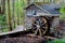 Small rustic building with water wheel