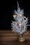 Small rustic table Xmas tree with golden straw decorations