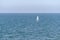 Small sailboat on calm sea water