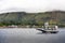 Small sailboat gliding through the calm waters of a tranquil lake surrounded by majestic mountains