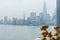 A small sailboats cruising in New York harbor in bad weather