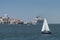 Small sailing boat in the Tagus River with the Lisbon skyline on the background