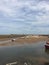 Small sailing boats moored at low tide, on the Norfolk coast estuary