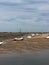 Small sailing boats moored at low tide, on the Norfolk coast estuary