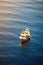 Small sailing ship in the open sea at sunset. Enchanting Serenity.