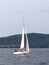 A small sailing sports yacht of daytime sailing is sailing with three yachtsmen along the coast of Croatia. Water sports and summe