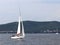 A small sailing sports yacht of daytime sailing is sailing with three yachtsmen along the coast of Croatia. Water sports and summe