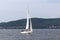 A small sailing sports yacht of daytime sailing is sailing with three yachtsmen along the coast of Croatia. Water sports and summe