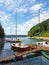 Small sailing yachts of coastal navigation are moored at the pier in a picturesque harbor. Prestigious and healthy lifestyle. Recr