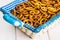 Small salted pretzels cookies in a basket on a white wooden table