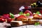 Small sandwiches with jerked ham, olives, tomatoes and red wine, rustic style, selective focus