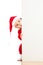 Small Santa baby looking behind placard bannere