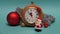 Small Santa Claus toy walking near Christmas New year decorations and clock