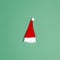 Small santa hat on green background