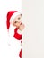 Small Santa toddler looking from behind placard