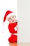 Small Santa toddler looking from behind placard