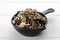 Small saucepan with aromatic dried lemongrass on white wooden table, closeup