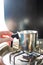 small saucepan with hot liquid on a gas stove in a camper van in winter