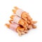 Small sausages wrapped in a blanket of smoked streaky bacon isolated on white background