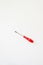 Small screwdriver of red color on a white background