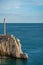 Small sea light marker on a cliff in Petrovac