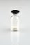 Small sealed bottle with medicine on white background