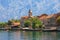 Small seaside village in the background of the mountains. Montenegro. View of Bay of Kotor and Stoliv village on sunny summer day